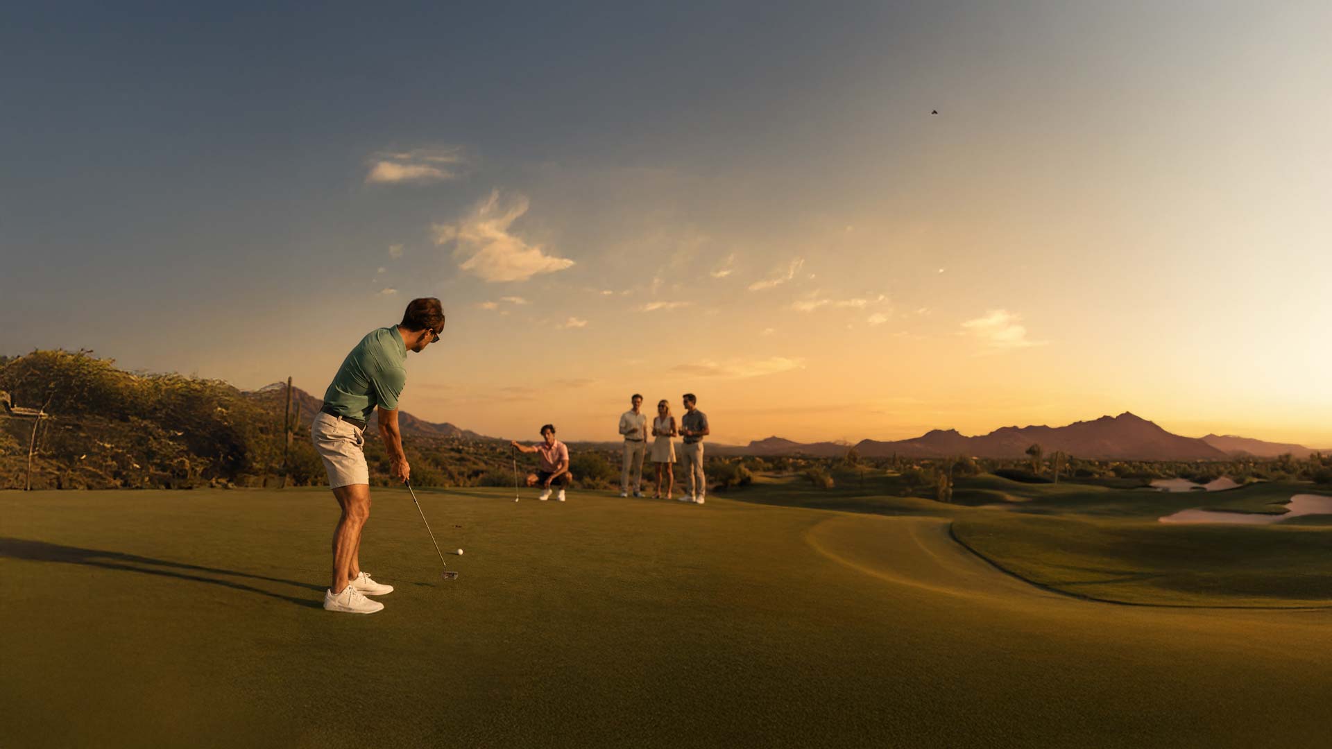 Man golfing with group at Troon North